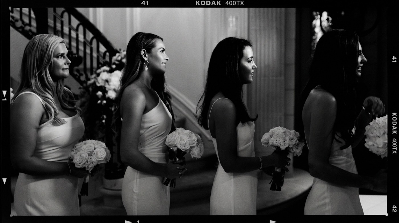 Kodak 400TX read as a contact strip. Four bridesmaids on one tonal scale.