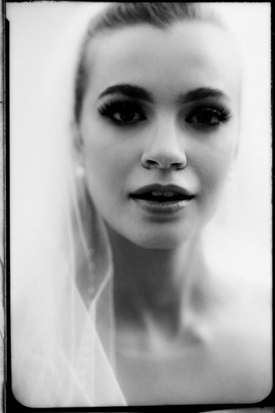 High-key black and white, soft focus held just short of losing the eyes.