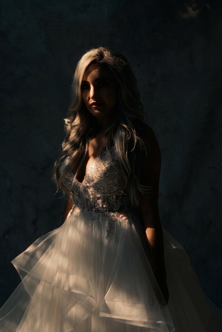 A portrait relit to a dramatic single-source side light, identity preserved.