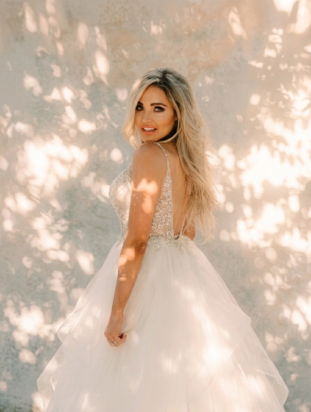 The same bridal portrait relit to warm, directional golden-hour light, subject unchanged